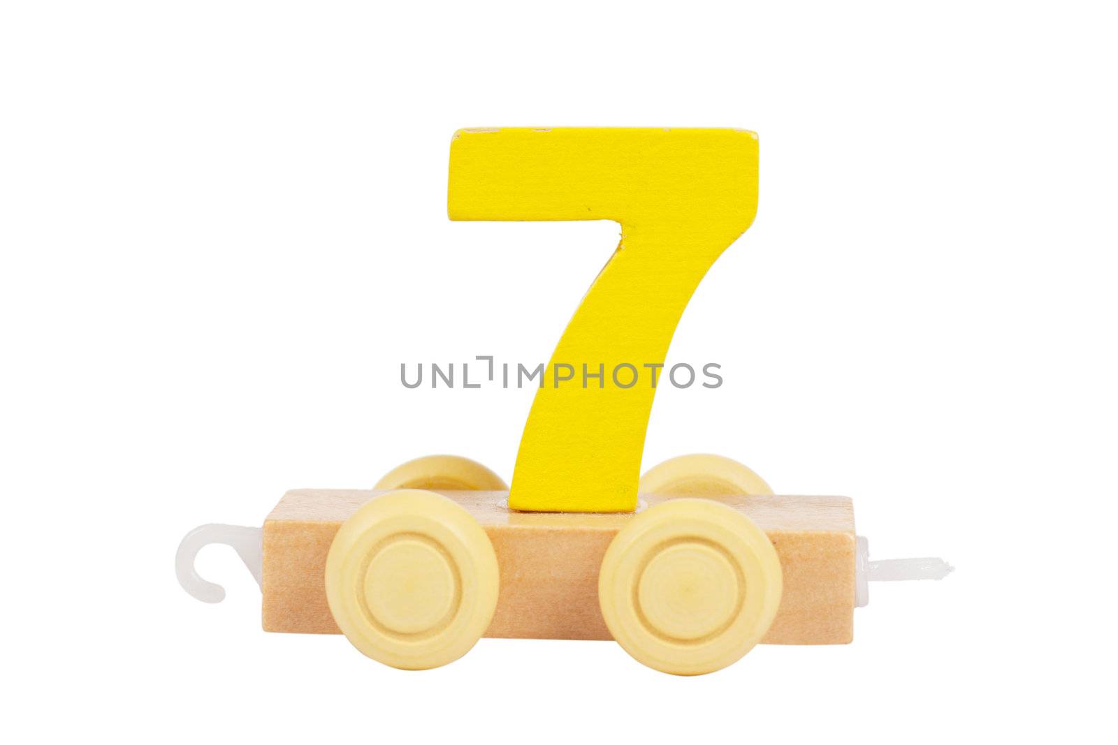 Wooden toy on a wheels number 7 isolated over white
