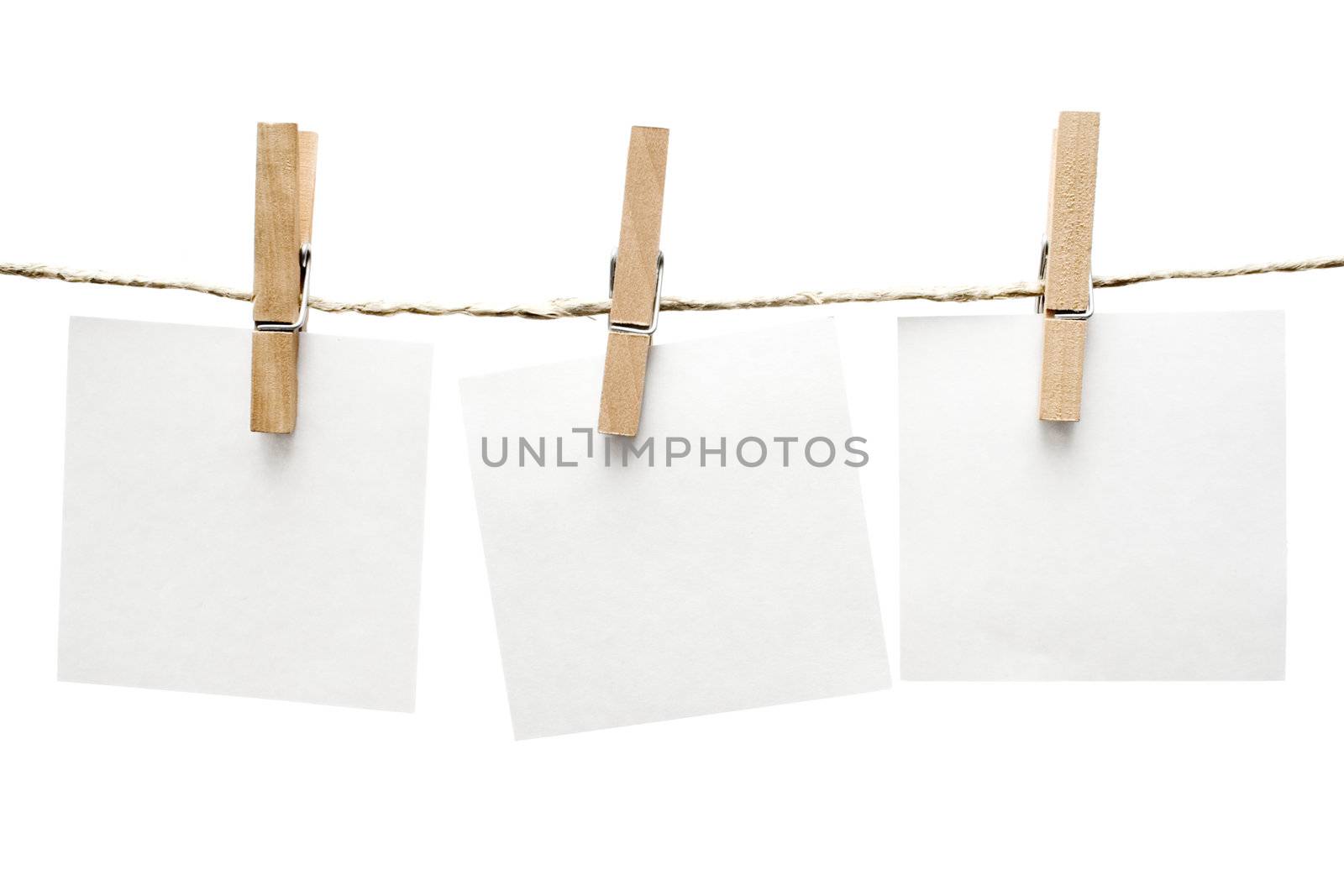 Three notes hanging on a clothesline. Isolated on a white background.