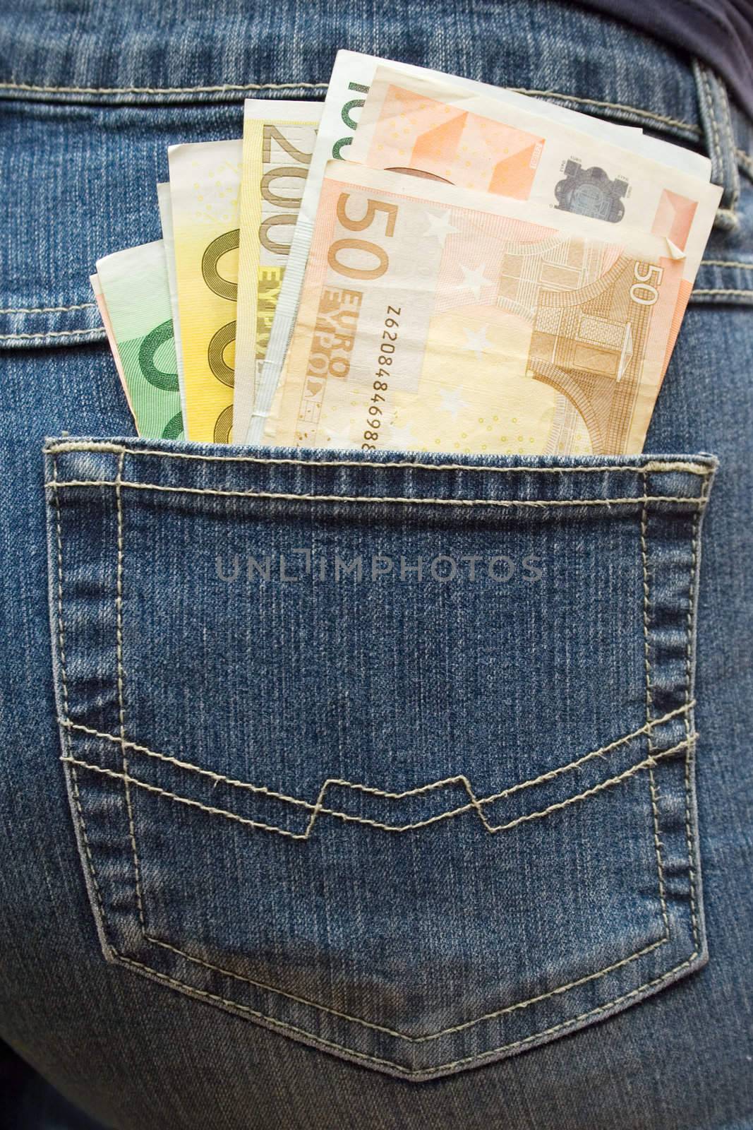 Bunch of Euro banknotes in a jeans pocket.