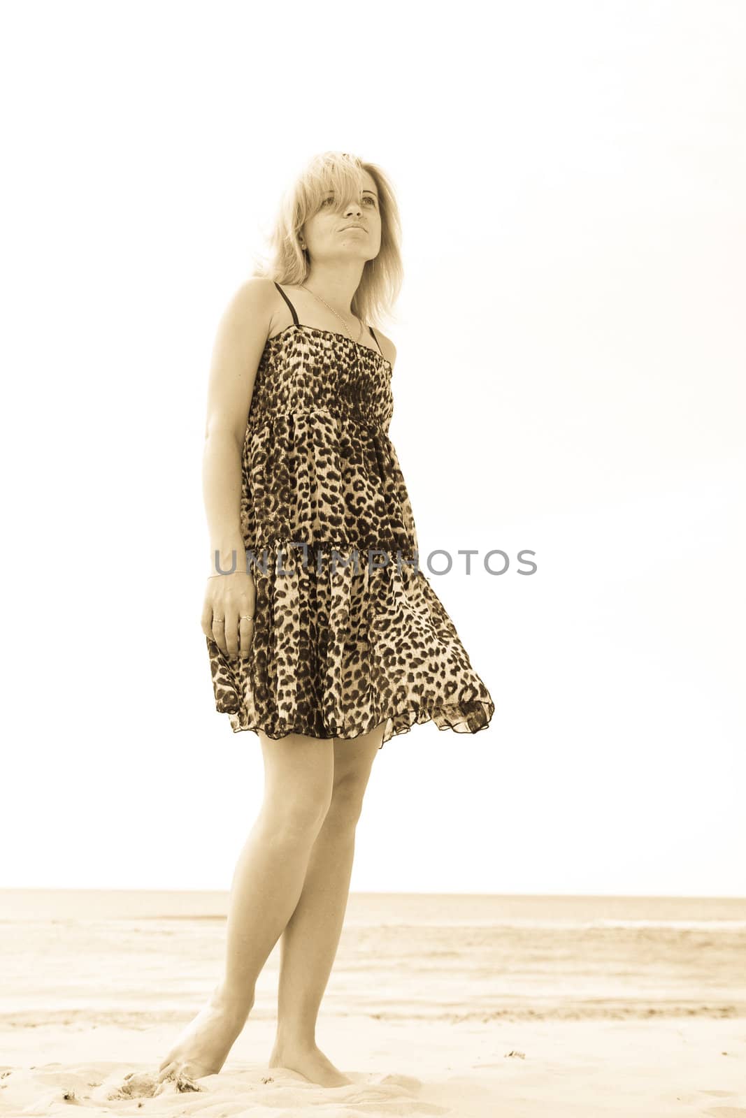 woman on the beach watching into the distance