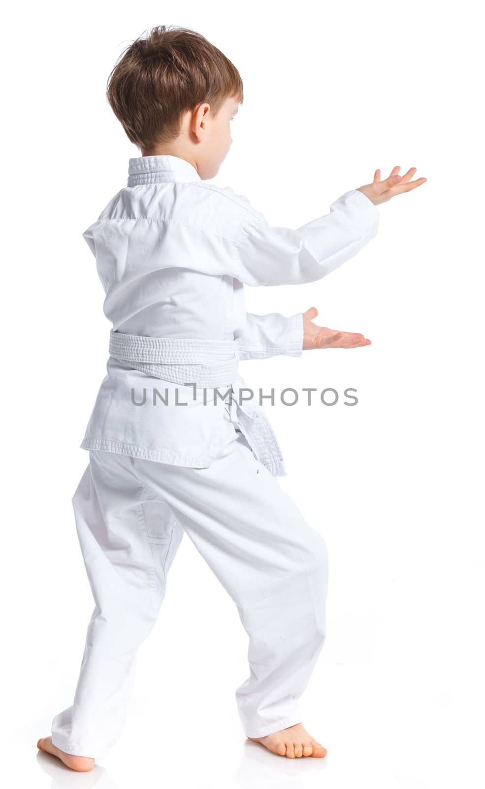 Aikido boy fighting position in white kimono isolated on white