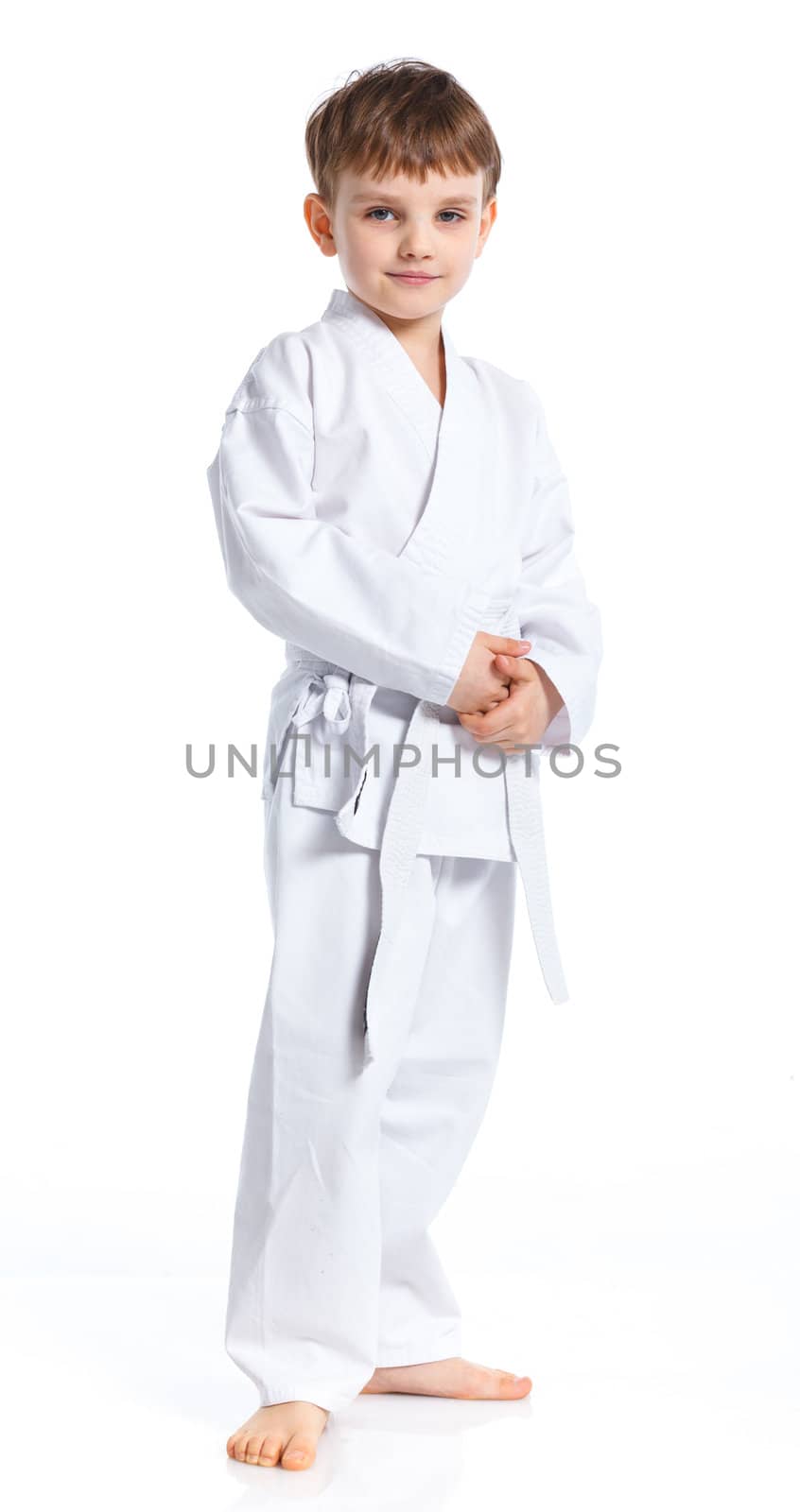 Aikido boy fighting position in white kimono isolated on white