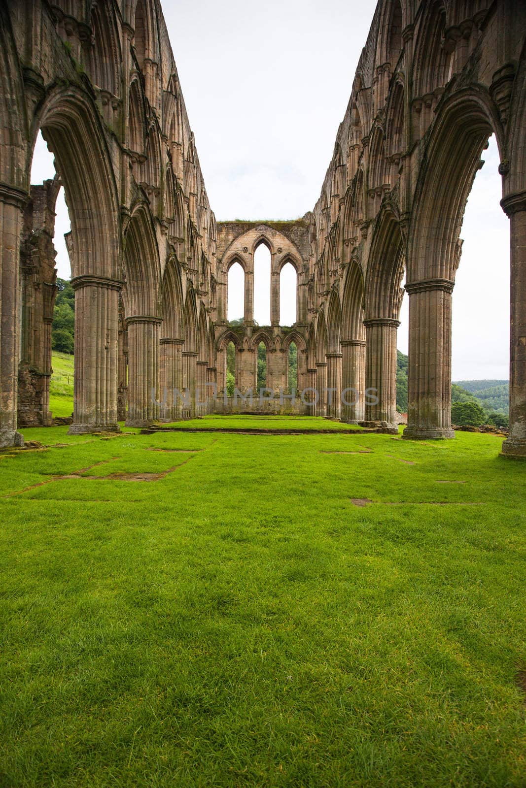 Scenic view of ruins of Rievaulx Abbey under cloudscape, North Yorkshire Moors, National Park, England