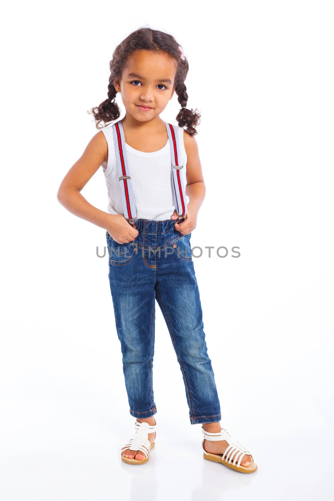 Cute little mulatto girl lying and smiling. Isolated on white background