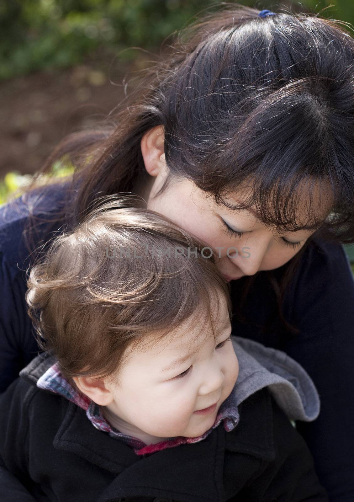 Close up of an asian woman with toddler. Soft focus