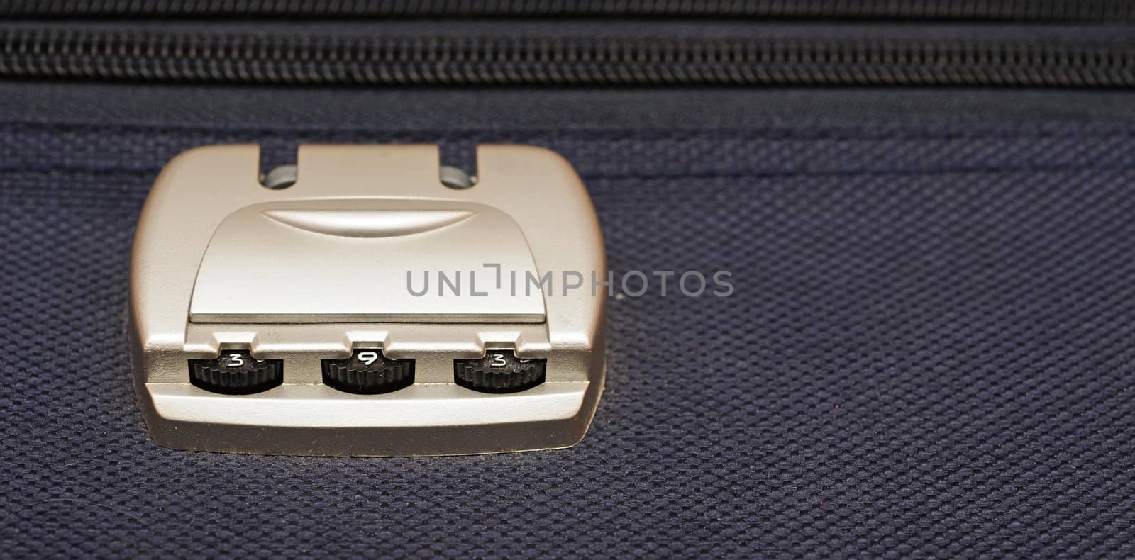 closeup photo of a combination lock on a black suitcase 