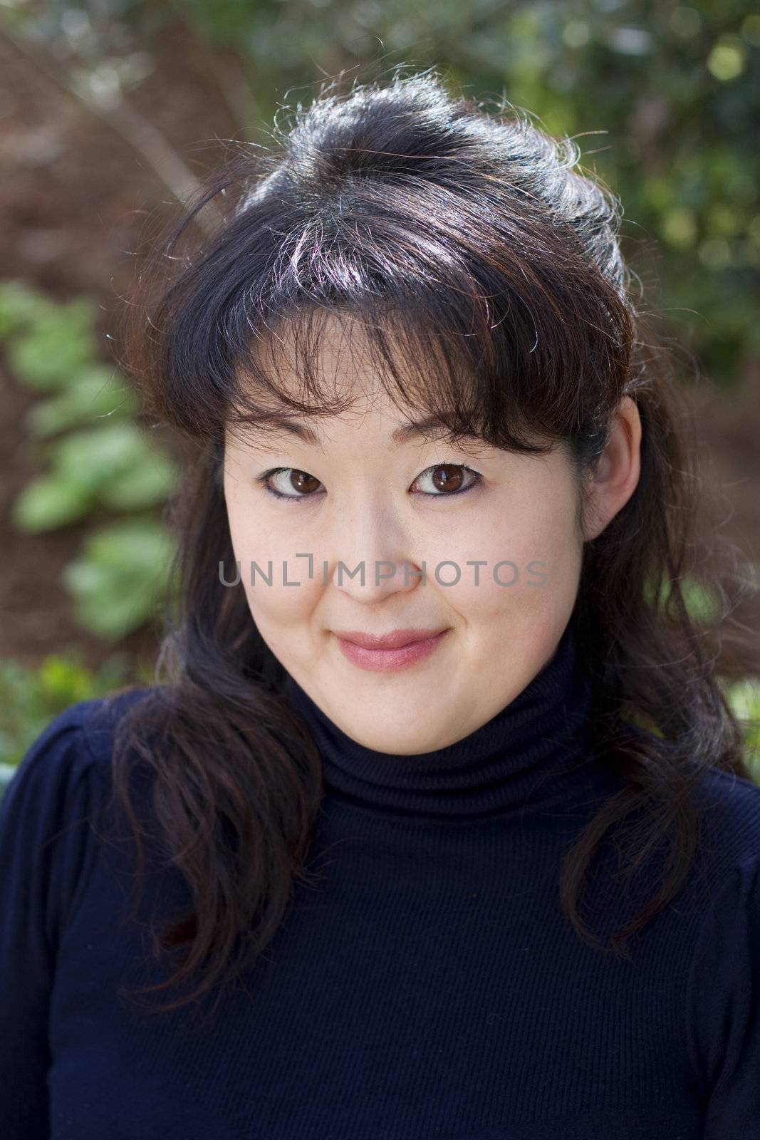 A close up photo outdoors of an Asian woman
