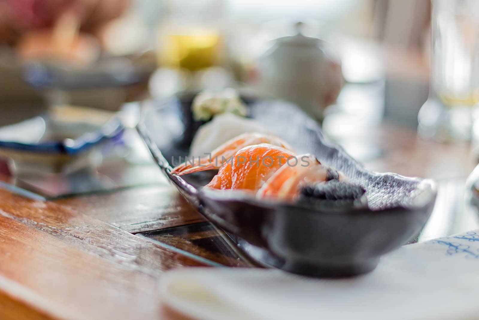 Closeup of delicious sushi set on traditional black plate