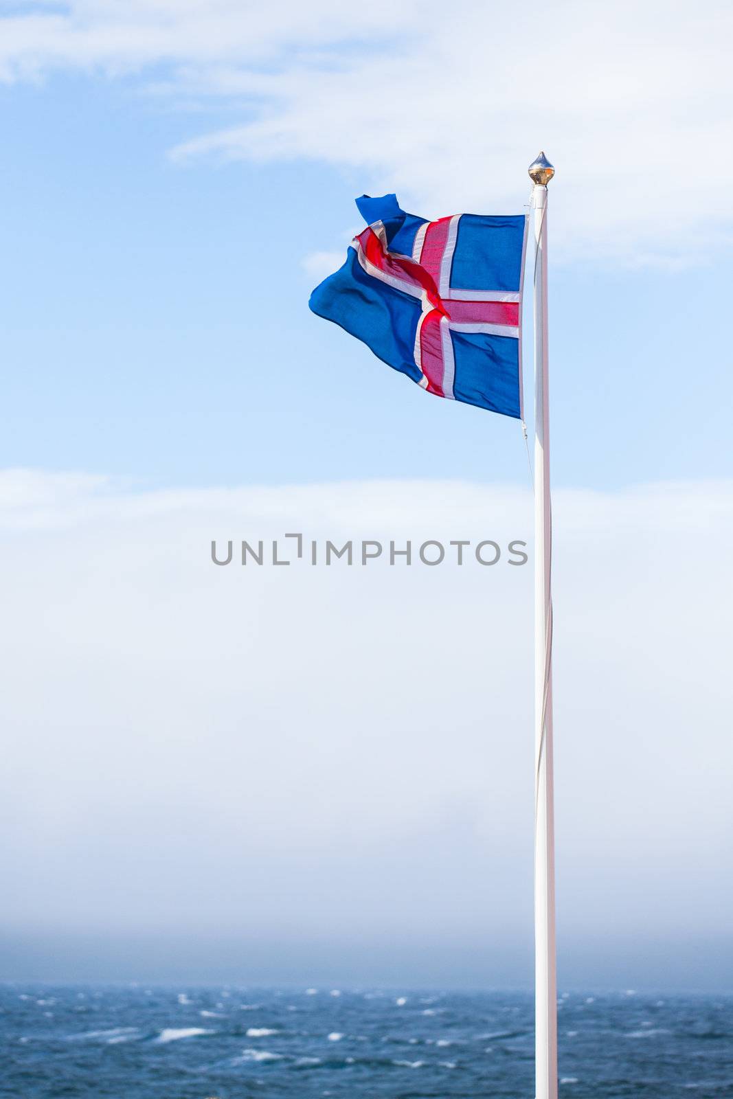 Icelandic Flag flying in summer seen against blue sky