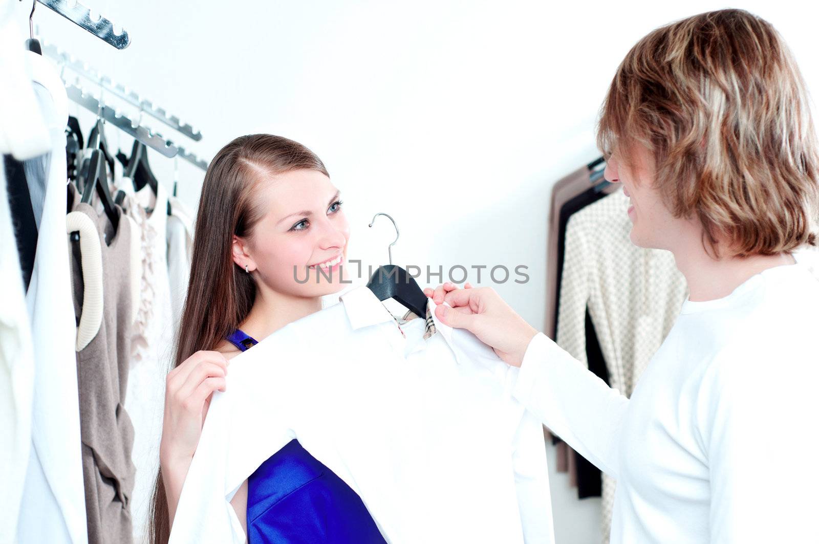 cute man and the woman in shop choose clothes