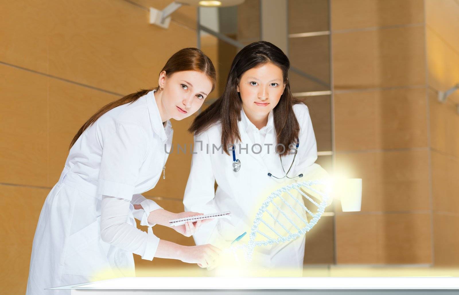 two doctors stand near glowing table discussing. projected objects on a desk