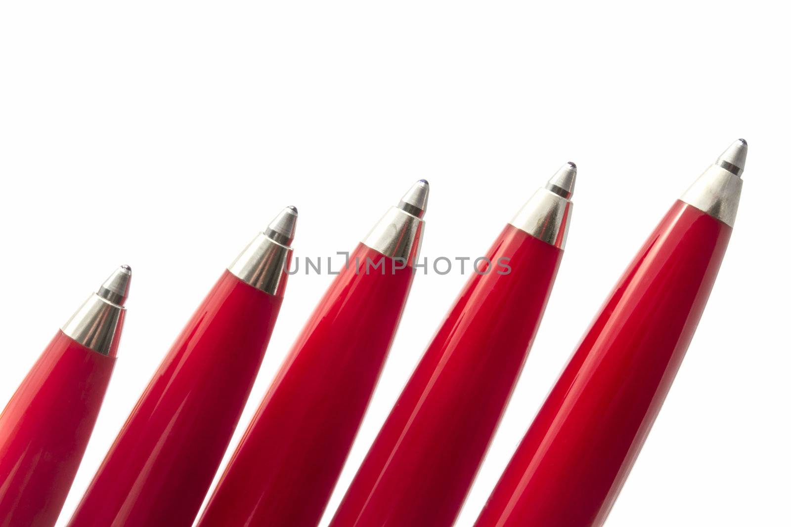Red pens closeup on white background