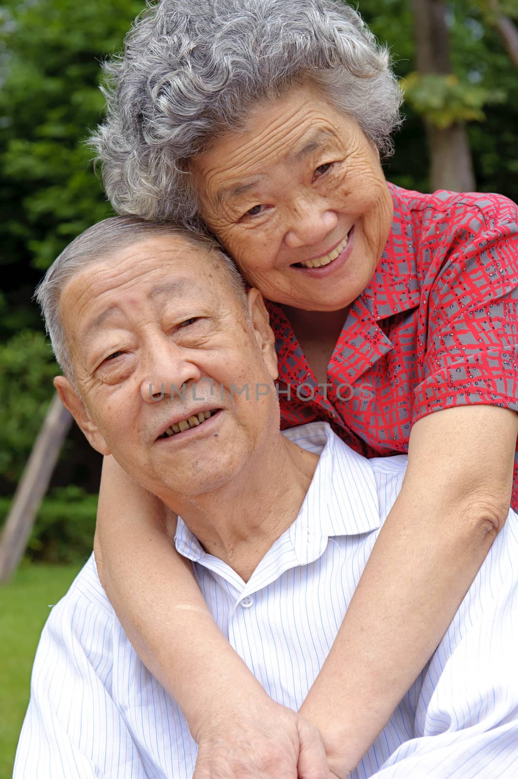 happy senior couple embraced by jackq