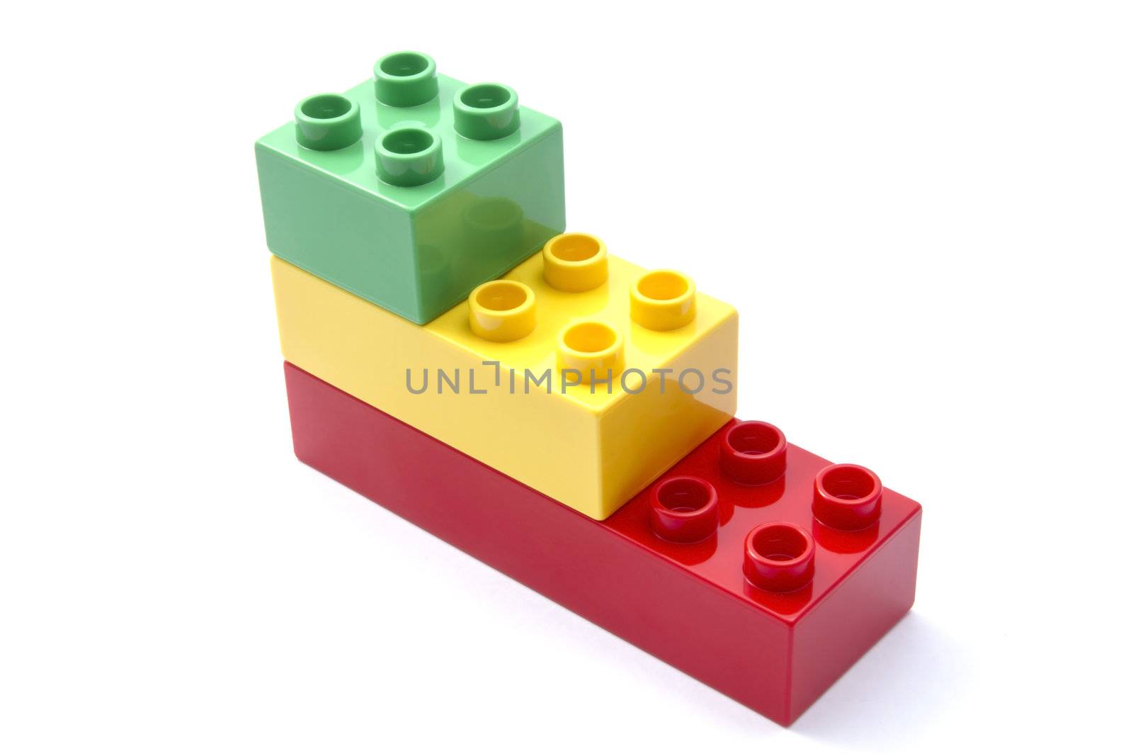 Colorful building blocks closeup on white background 