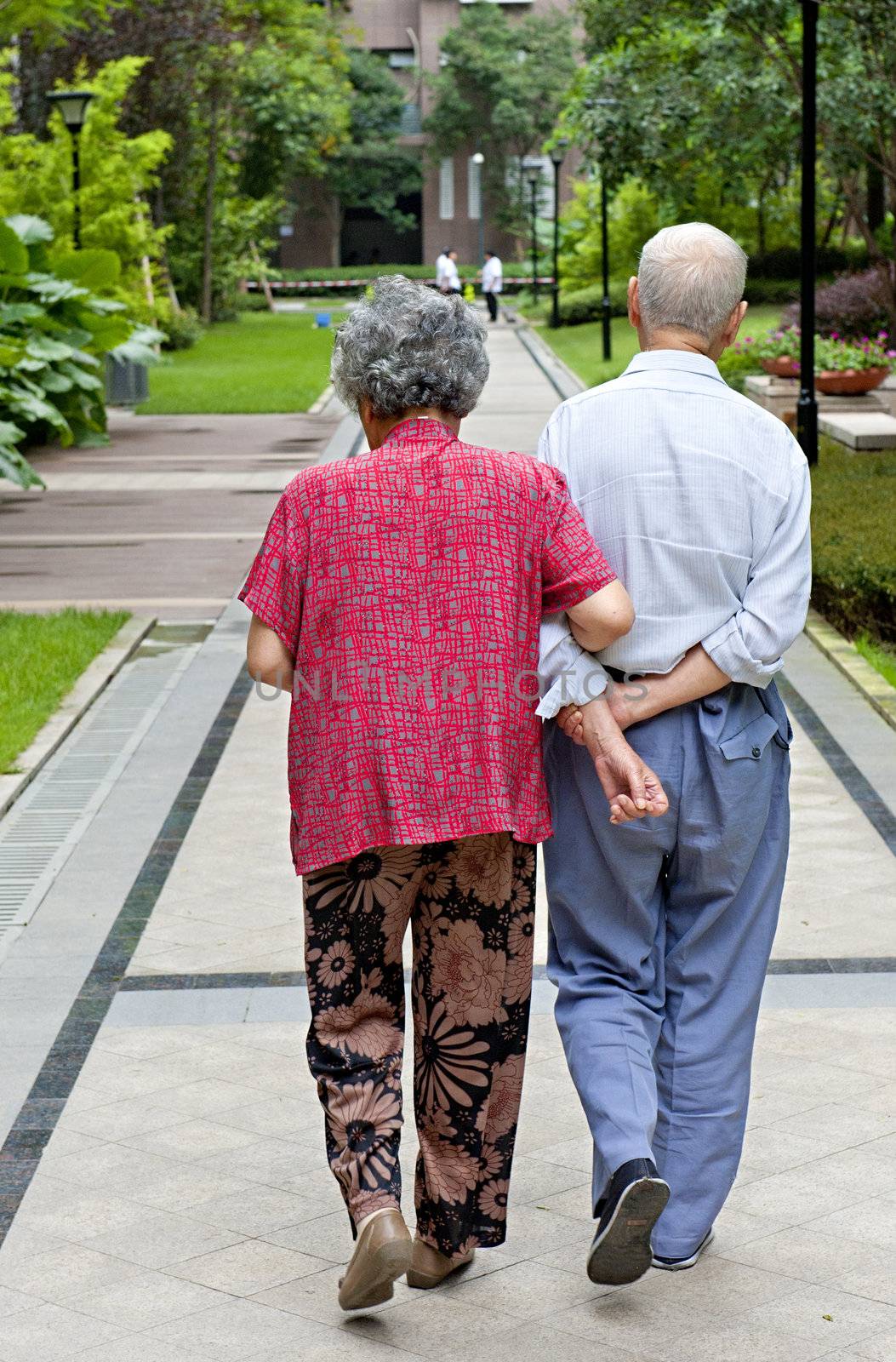 an intimate senior couple are walking