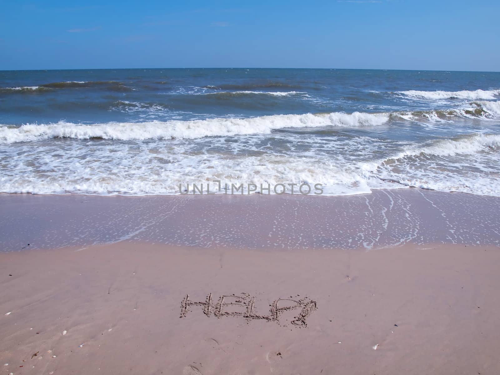 Help drawn on the sand in tropical beach