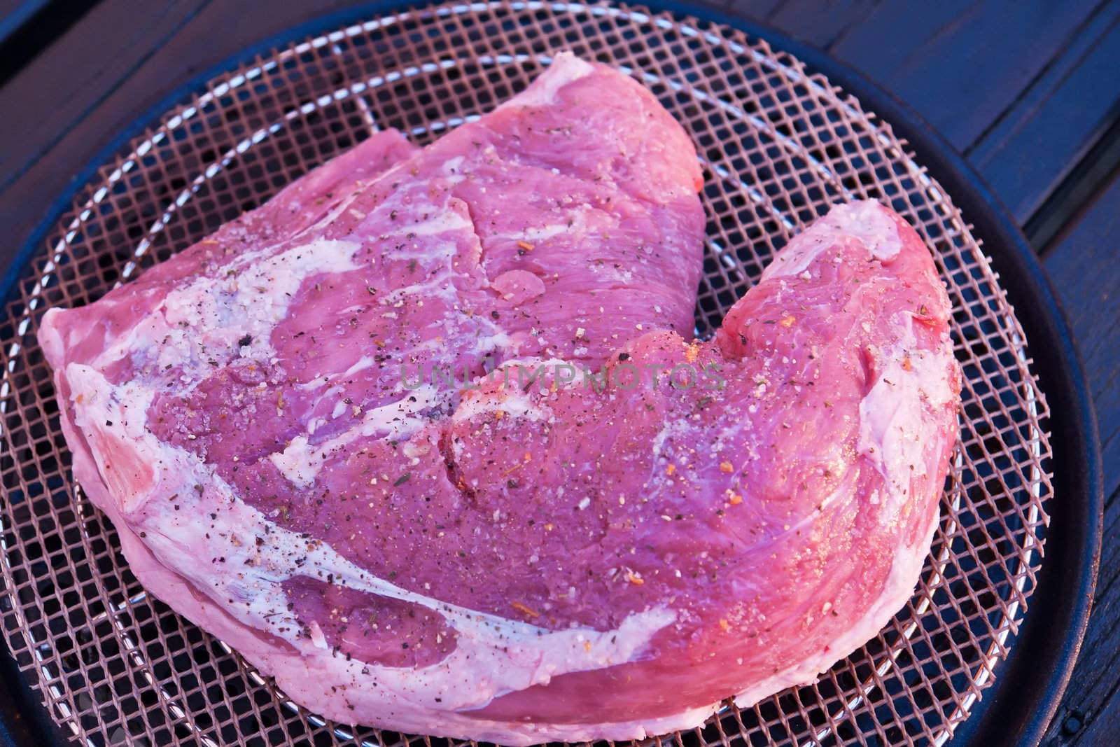 Closeup of a juicy steak made on a charcoal BBQ grill 