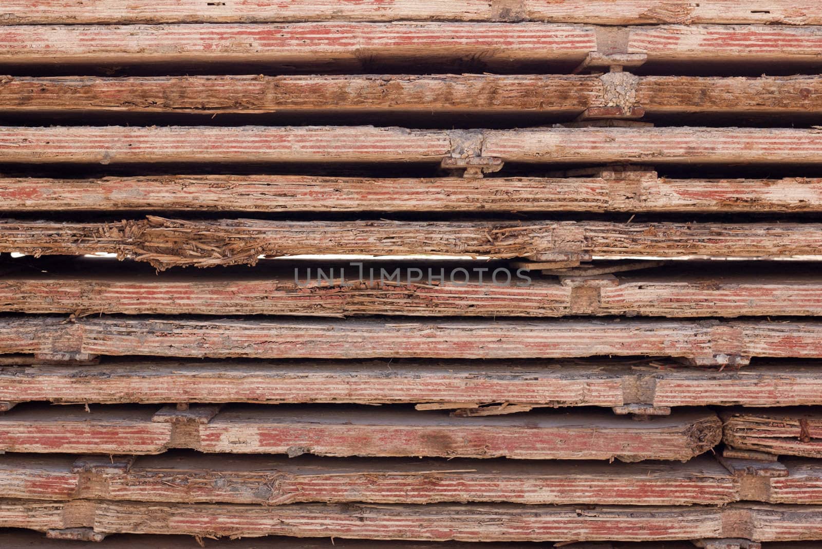 Stacked used red form boards with chips and brackets