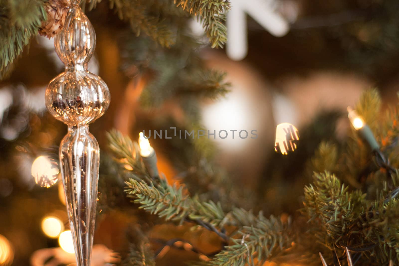 gold glass ornament hanging on a Christmas tree