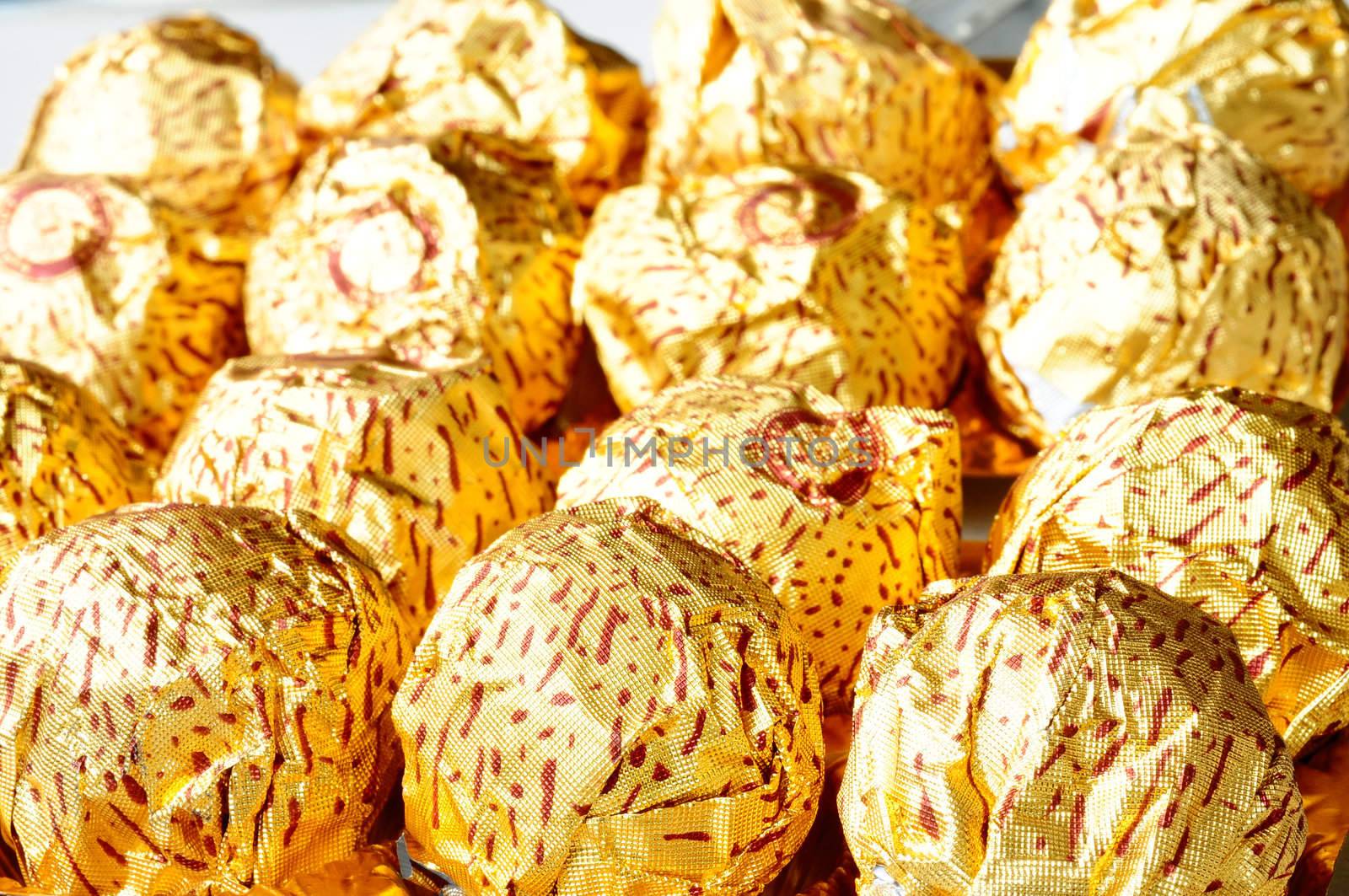 Chocolate wrapped in golden paper by bbbar
