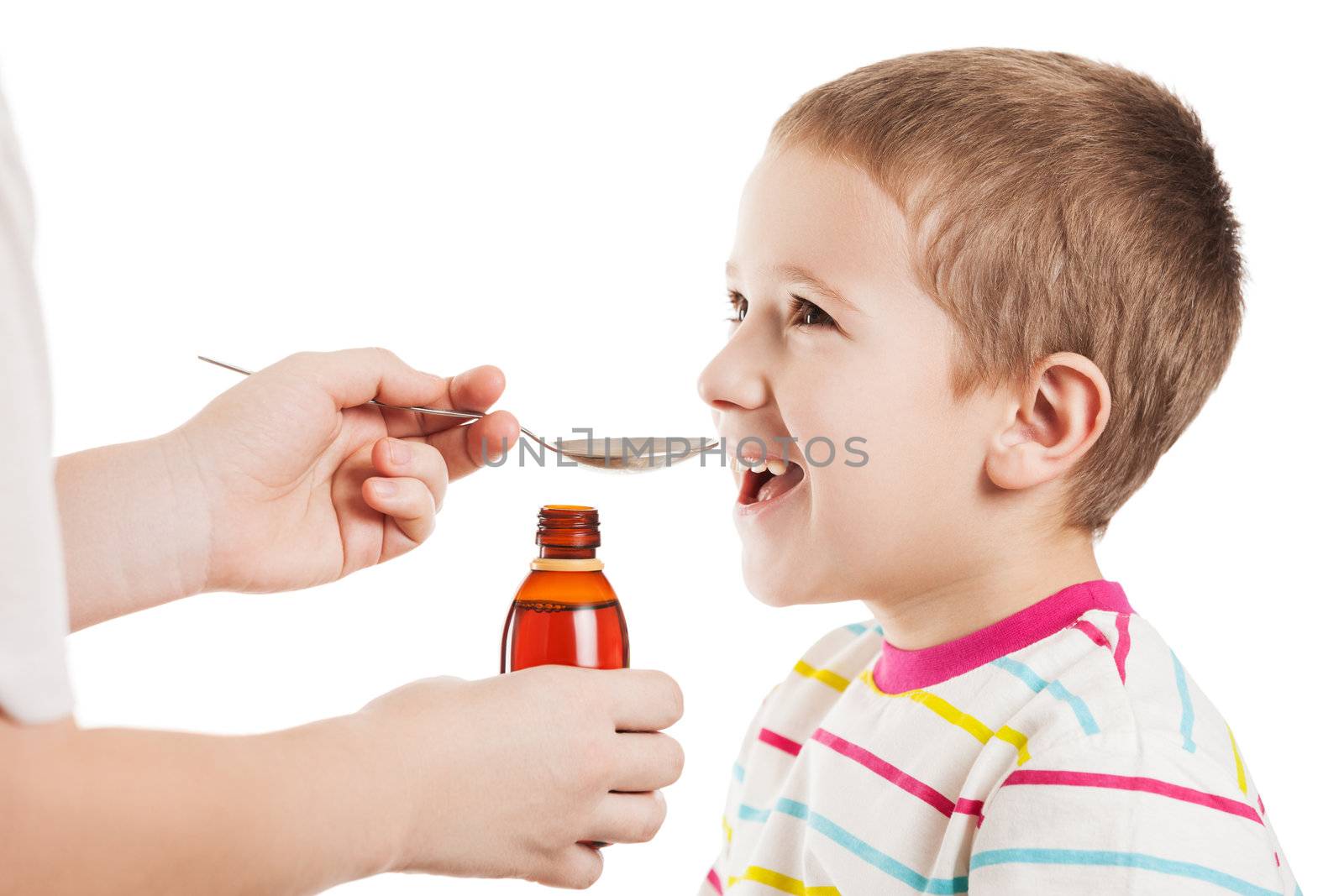 Doctor hand giving spoon dose of medicine liquid drinking syrup to child boy patient