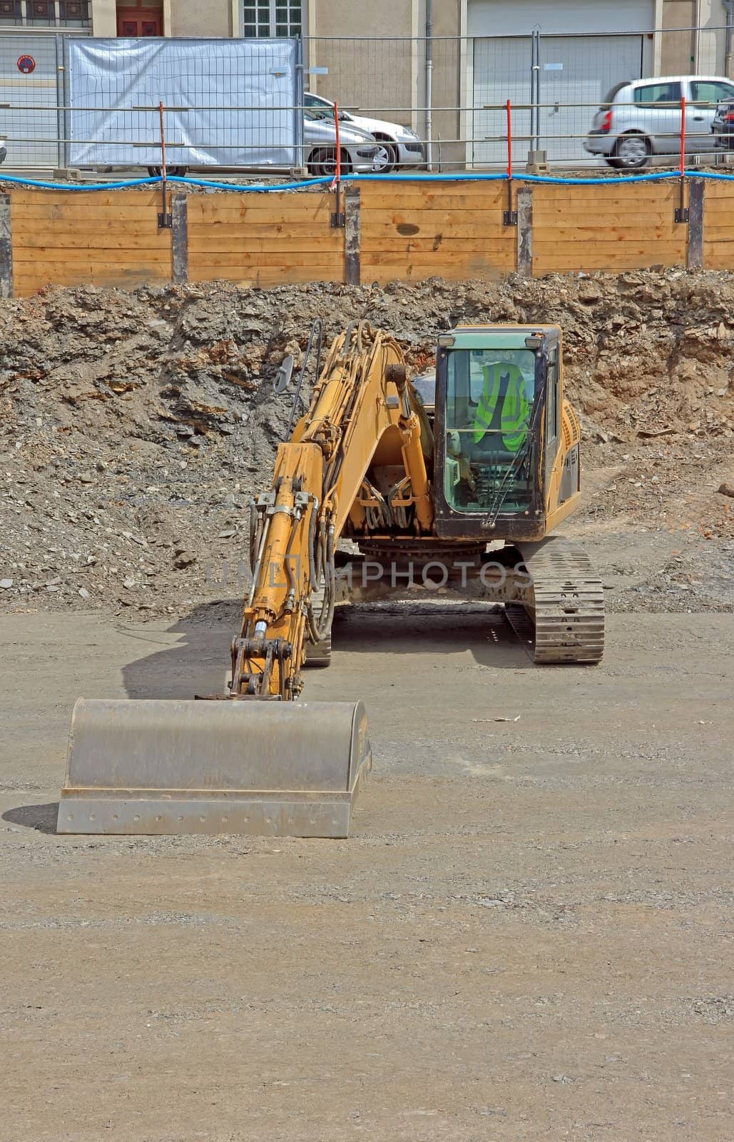 backhoe parked on site awaiting return to work