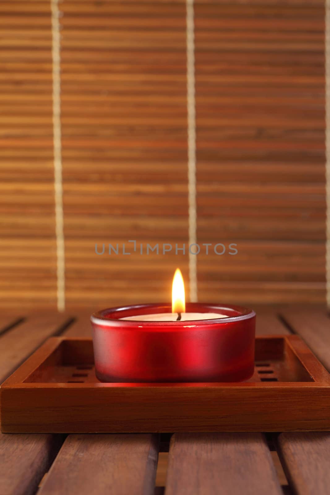 candle on the brown wooden table top