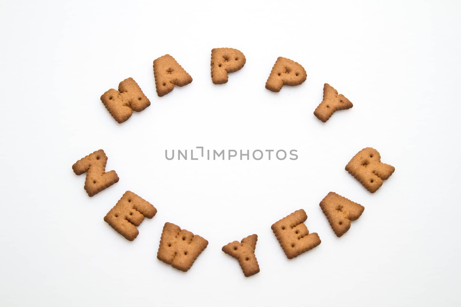 Happy New Year greeting words made by brown biscuits in center of white surface in landscape orientation for background use
