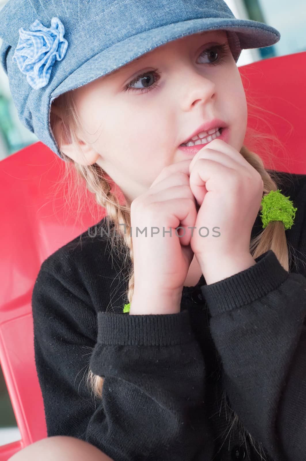 Portrait of little girl in denim hat