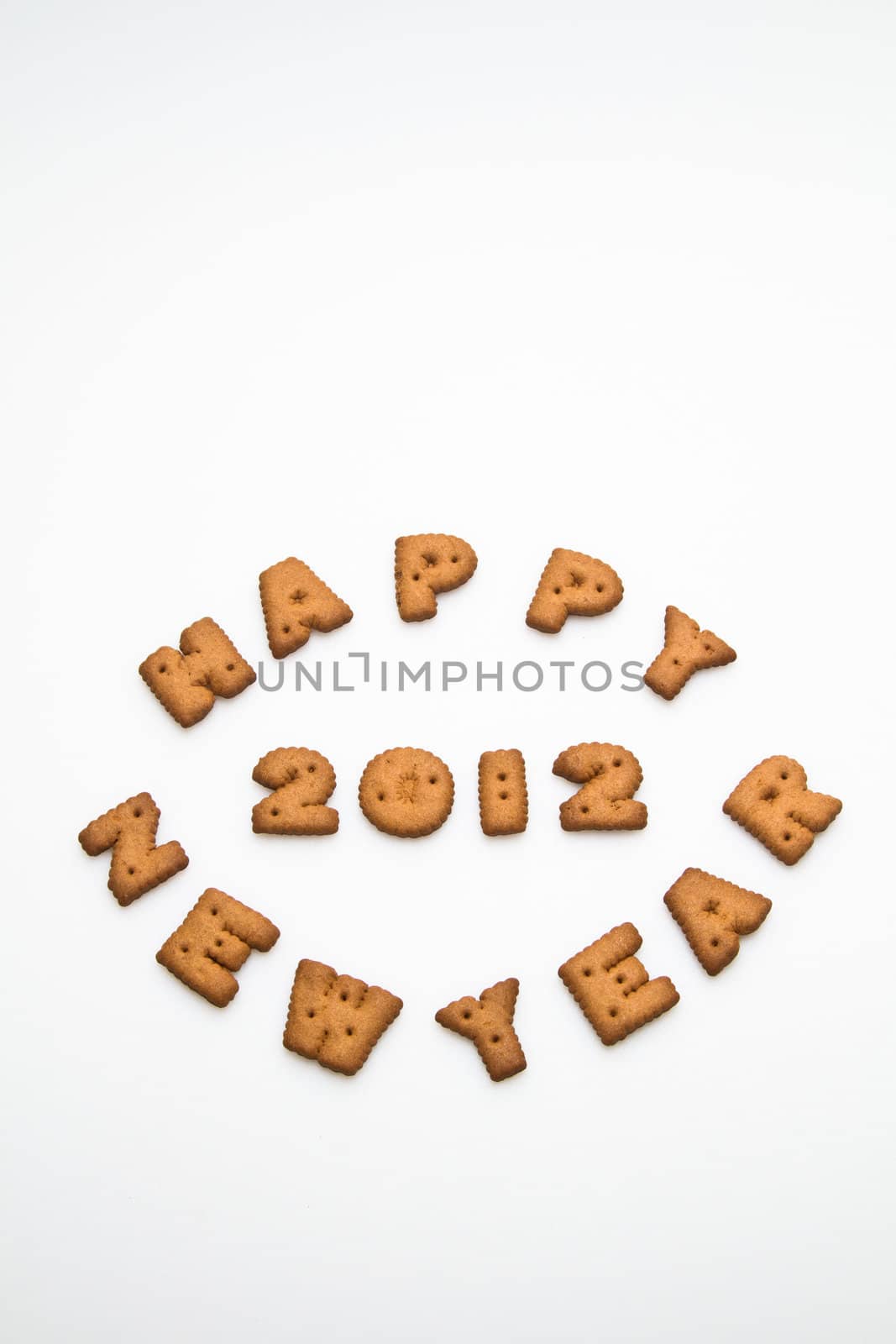 Happy New Year 2012 greeting words made by brown biscuits in lower center of white surface in portrait orientation for background use