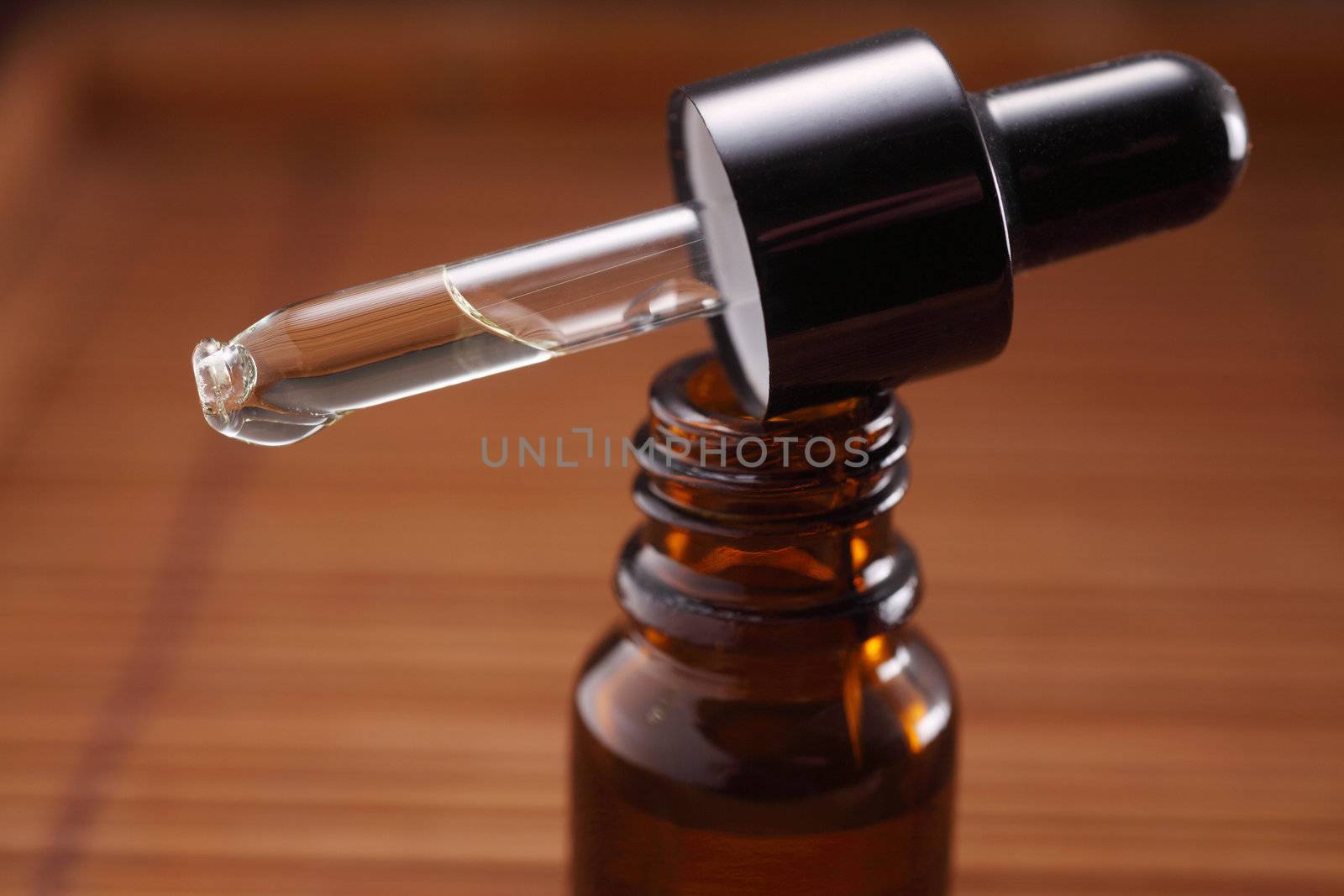 dropper on top of the bottle of massage oil