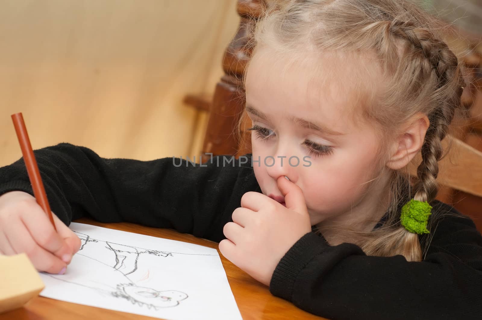 Little girl in black top is drawing