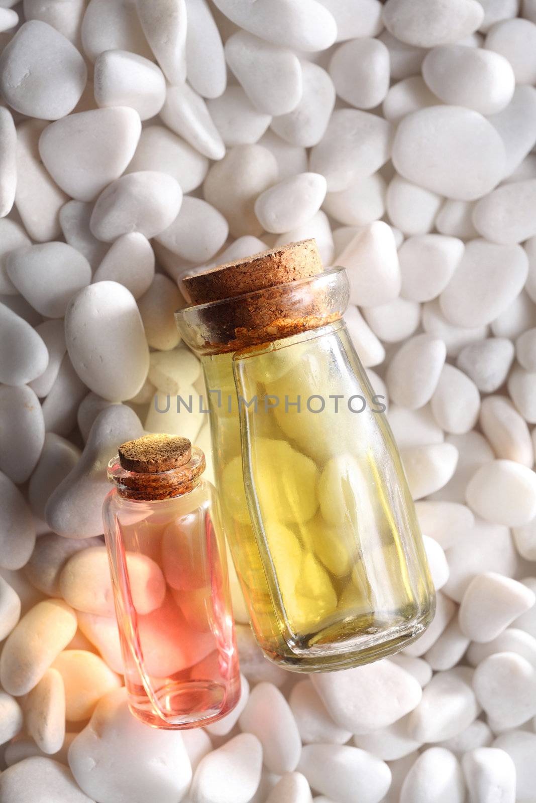 bottles of the massage oil on white stone
