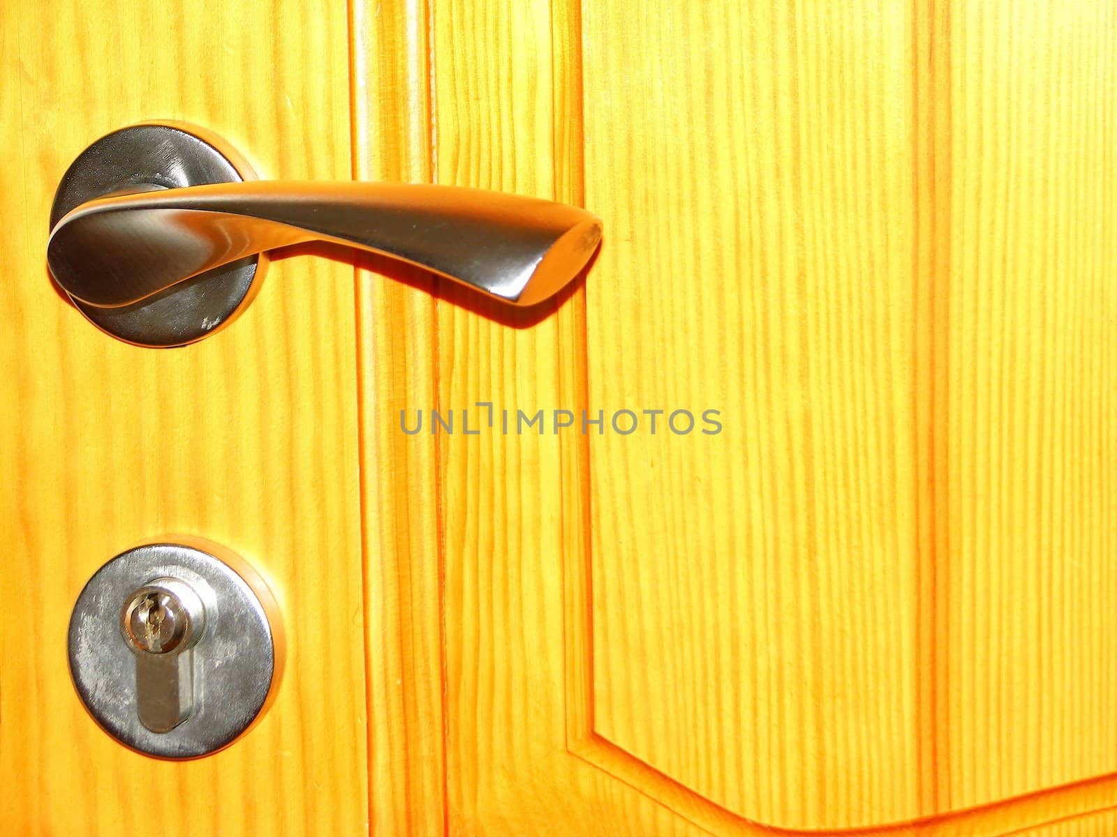 The Metal handle on a wooden door