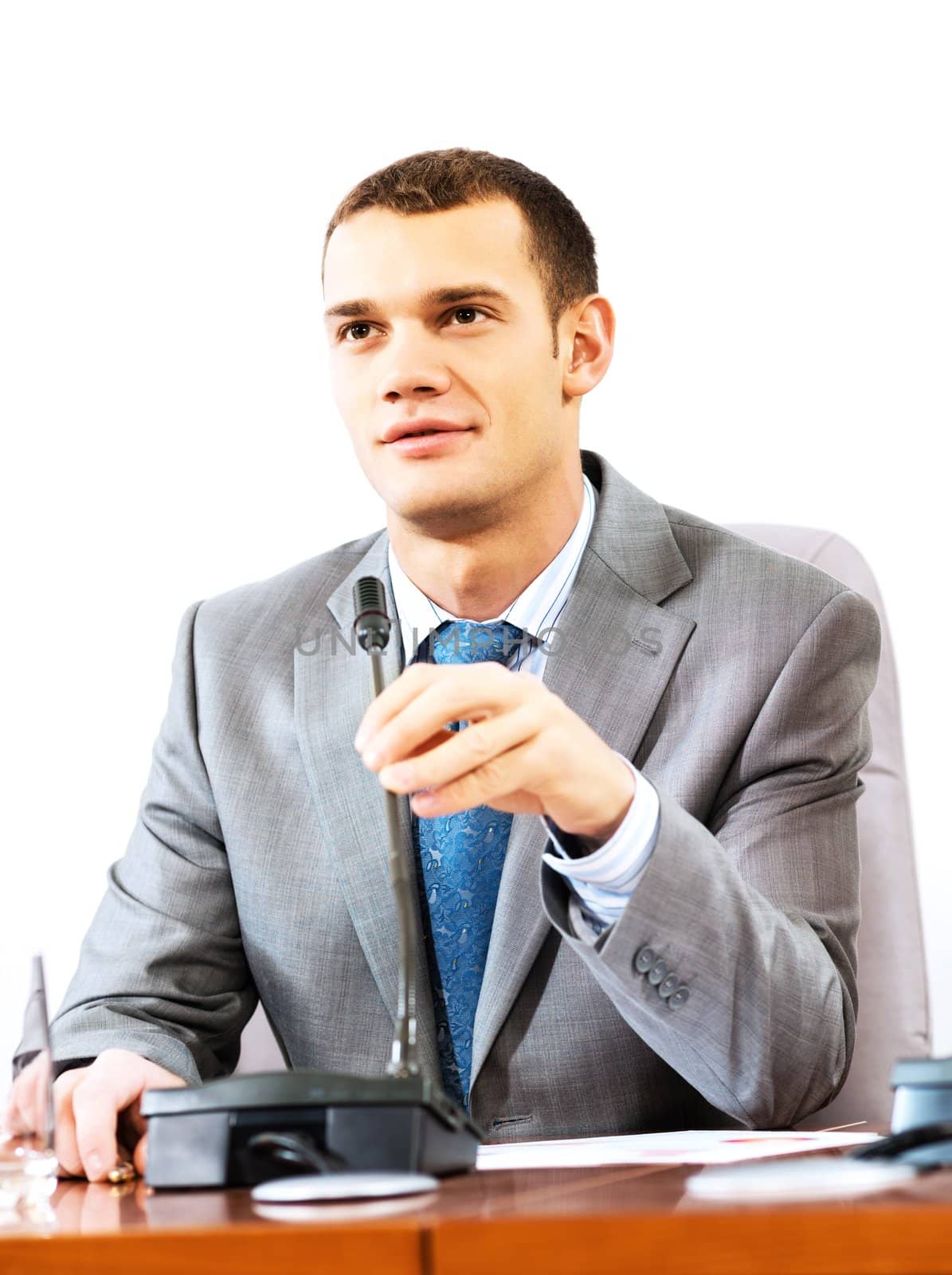 Portrait of a businessman, said into the microphone, the meeting