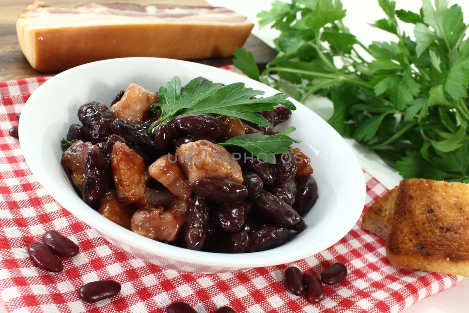 a bowl of kidney beans, parsley and bacon