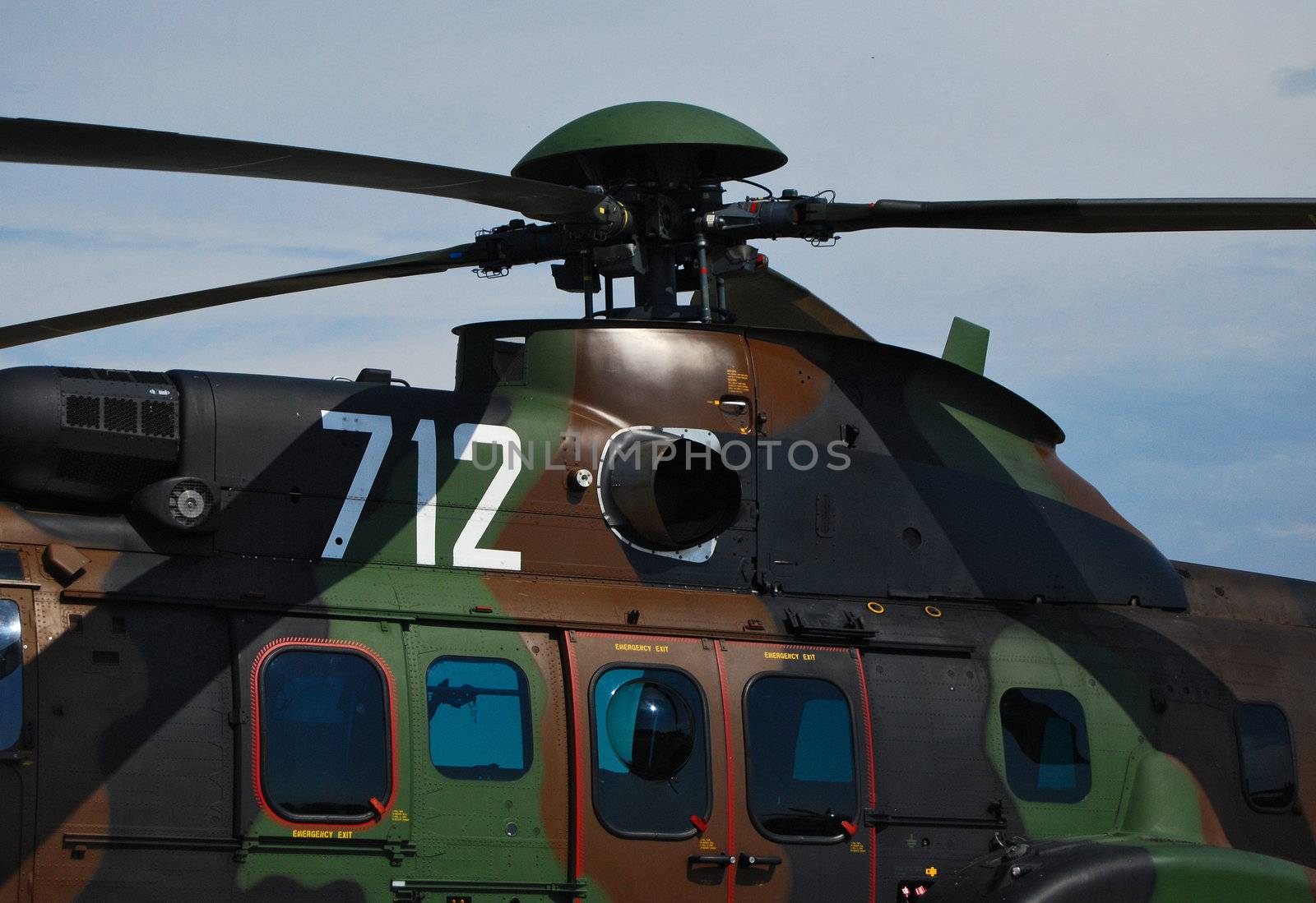 Camouflage painted helicopter and rotor close-up