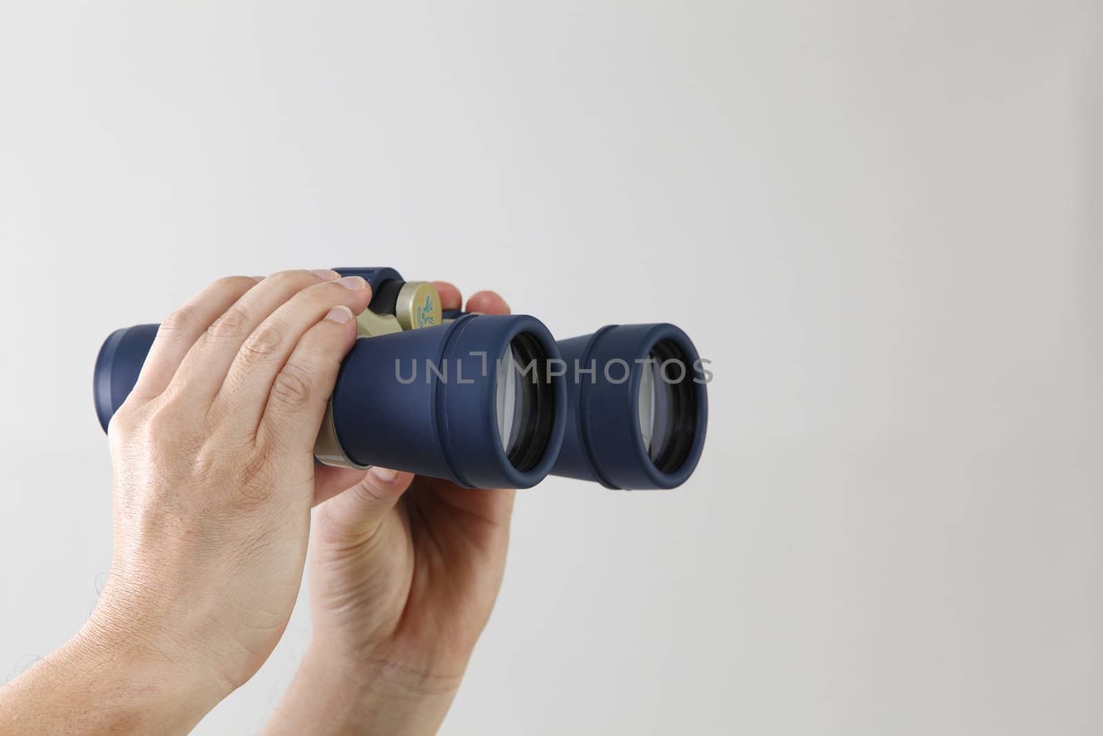 stock image of the hand holding the binocular