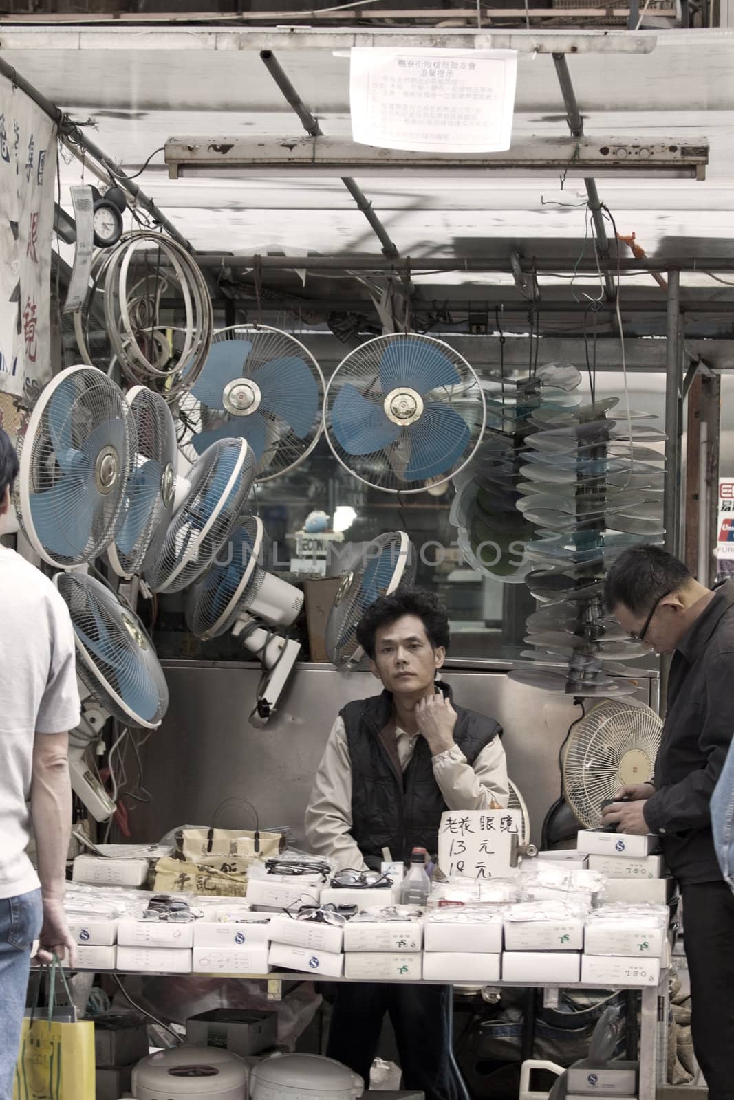 HONG KONG - 17 DEC, A Chinese hawker is selling electric appliances and other accessories in Ap Liu Street, Hong Kong on 17 December, 2011. It is one of the famous street in Hong Kong.