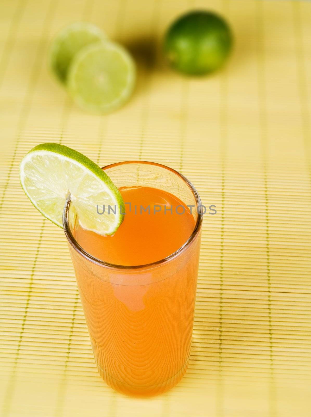 Orange juice with a lime slice