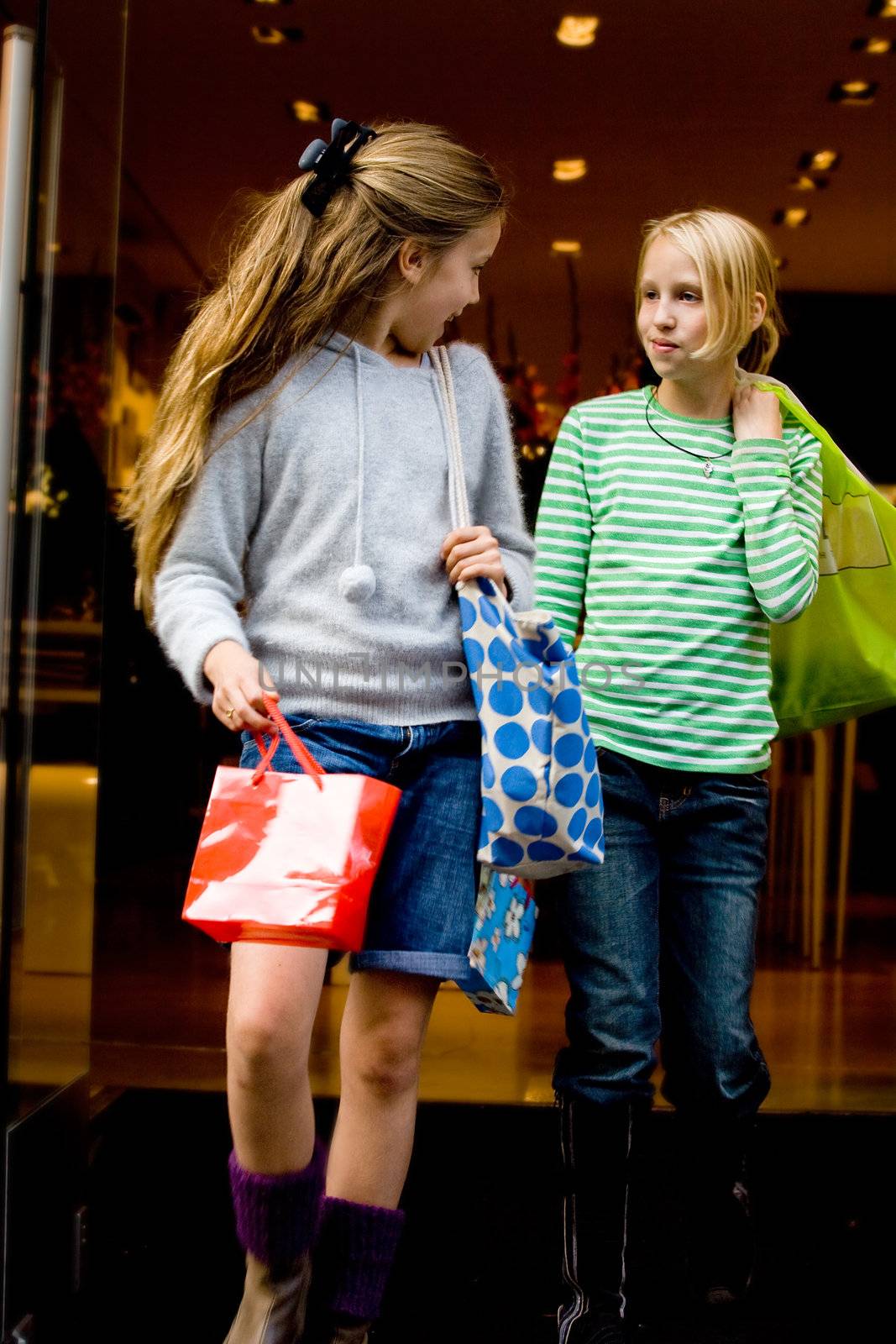 Two yuong children hanging around the streets while shopping