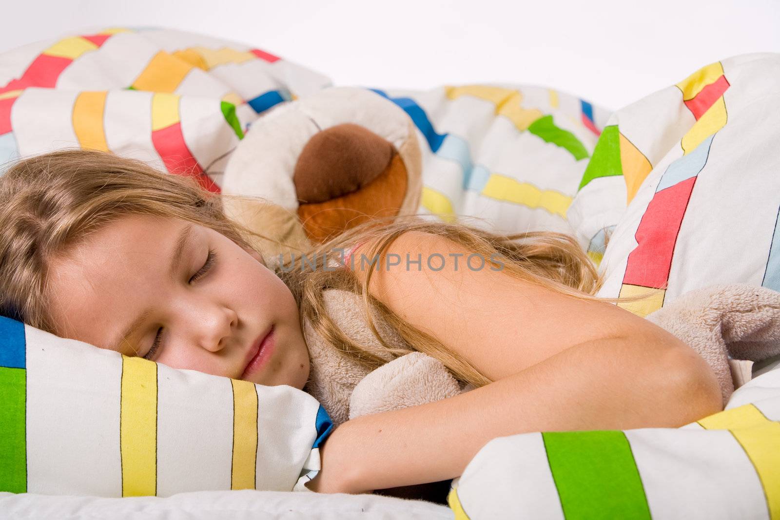 Sleeping young cute child in a colorful bed