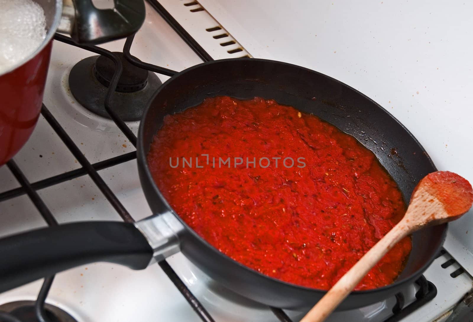 Pan on stove full of tomato sauce