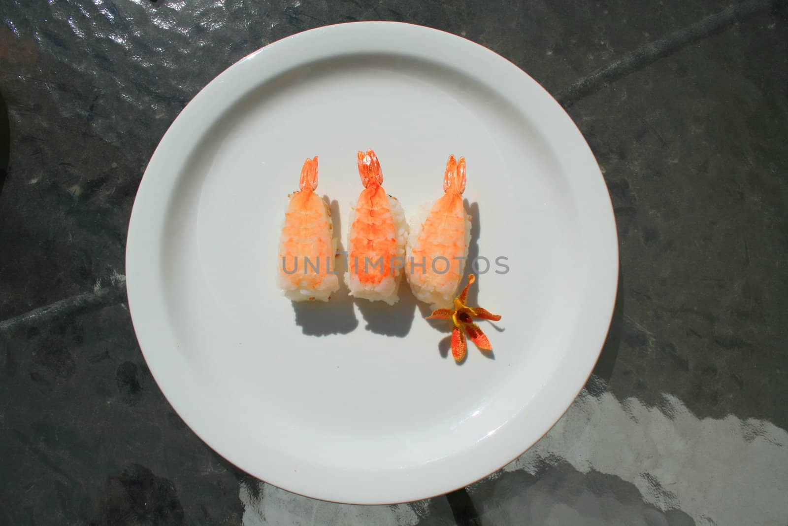 Close up of shrimp sushi on a plate.
