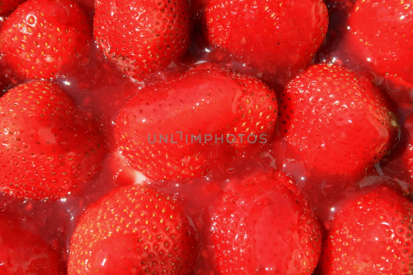 Close up of ripe strawberries in jelly.
