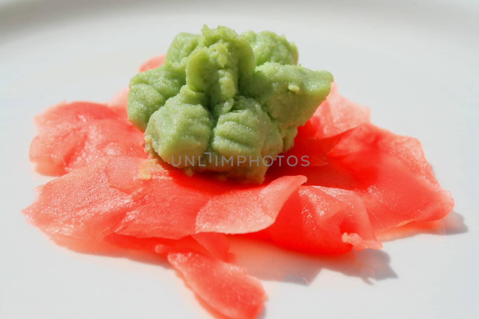 Wasabi and sushi ginger on a plate.
