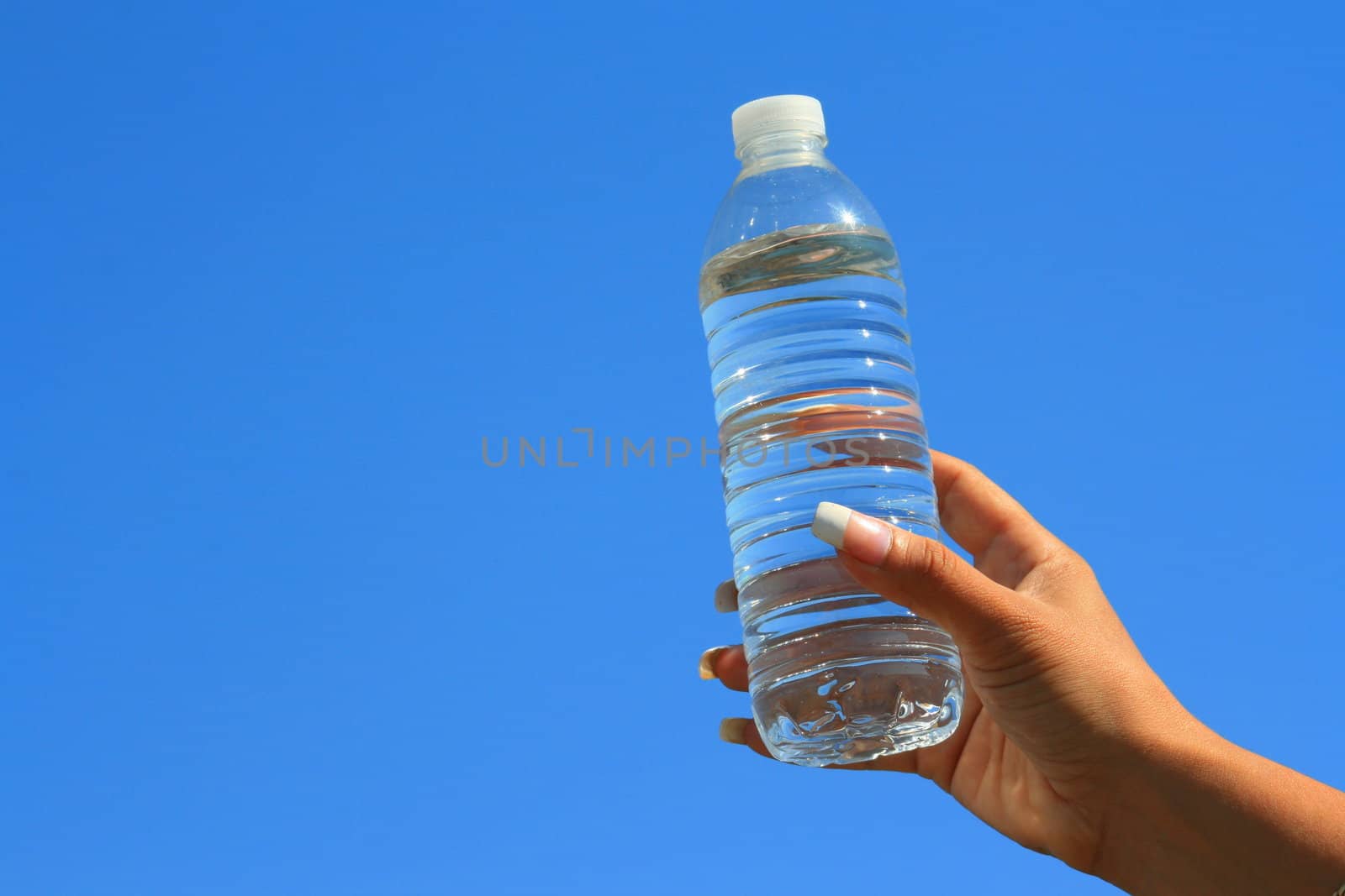 Close up of a woman's hand holding water bottle.