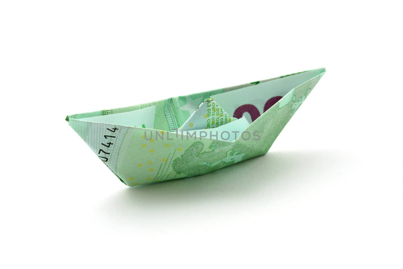 a boat folded of euro note isolated on white background
