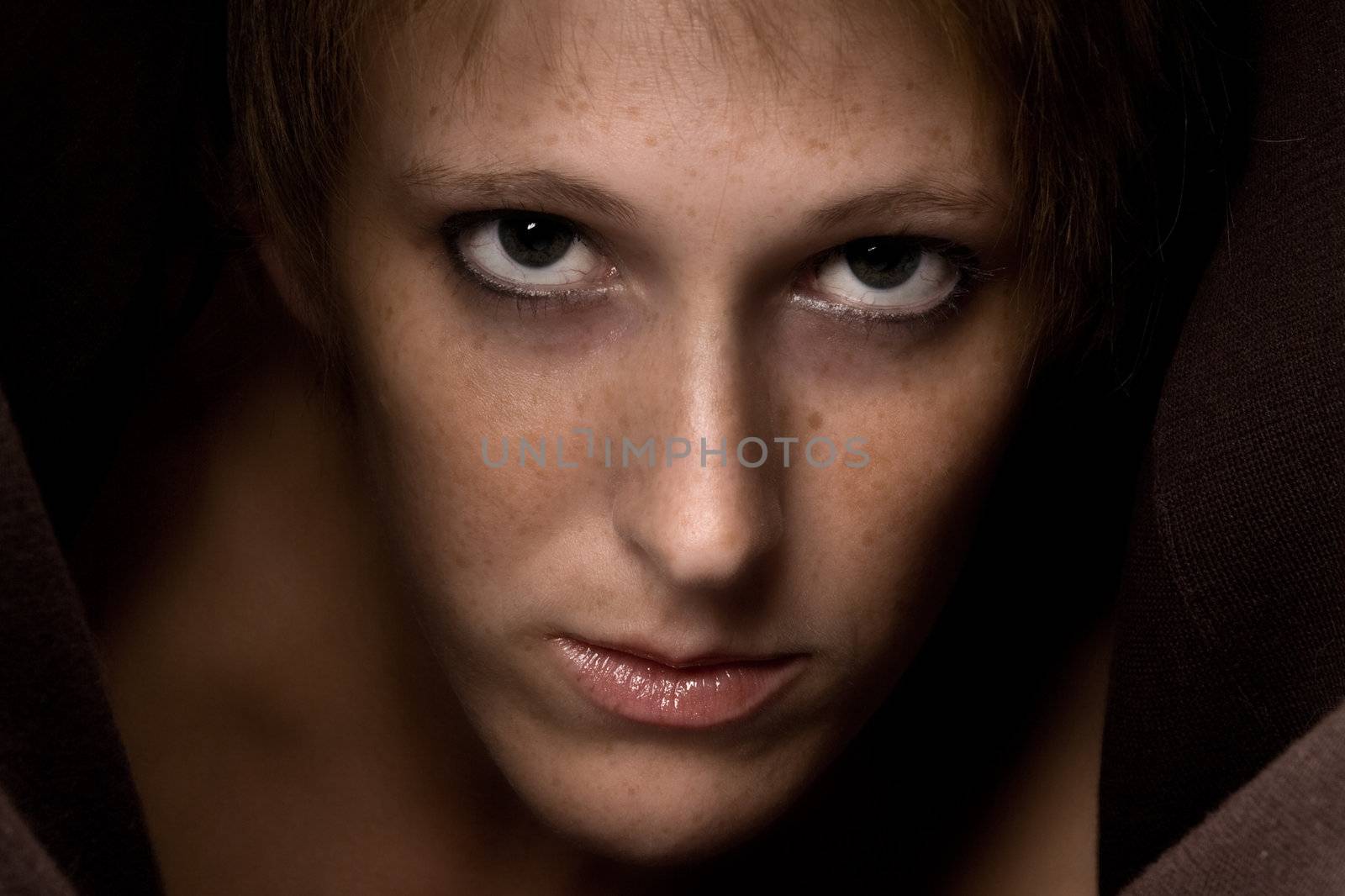 Studio portrait of a cute and beautifull girl in a turtle neck sweater staring at you