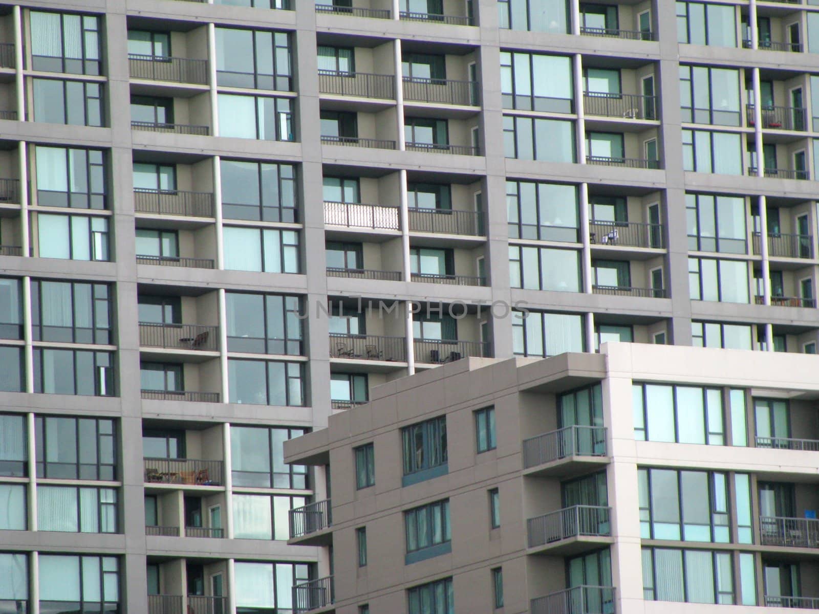 Abstract shot of a high-rise condo or apartment building with windows and balconies.